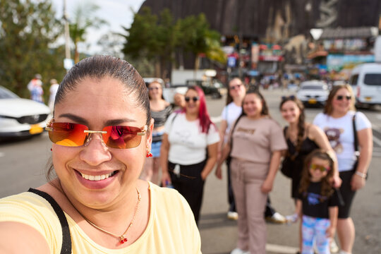 Happy people taking selfie on vacation in guatape