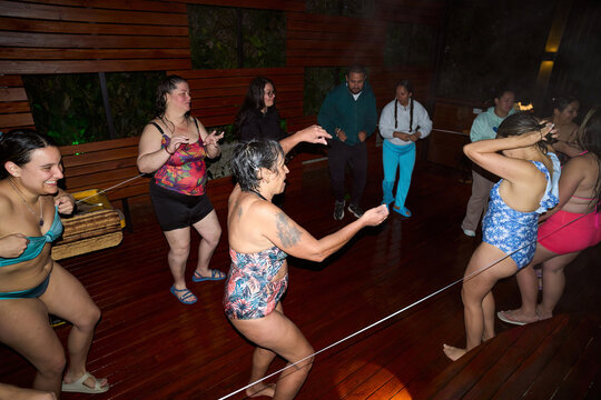 Diverse group of people dancing together on a wooden deck