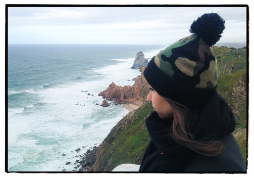 Woman overlooking Atlantic cliffs at Cabo da Roca Portugal