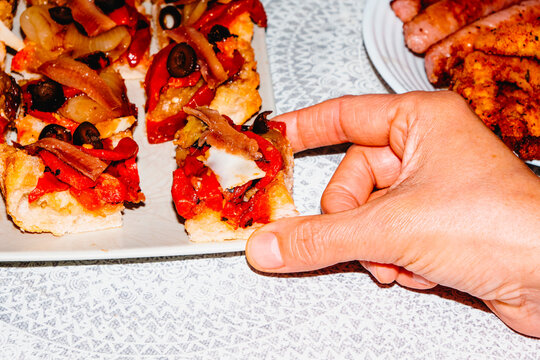 a man holding a slice of Catalan coca