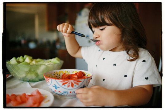 Close up of child eating strawberries