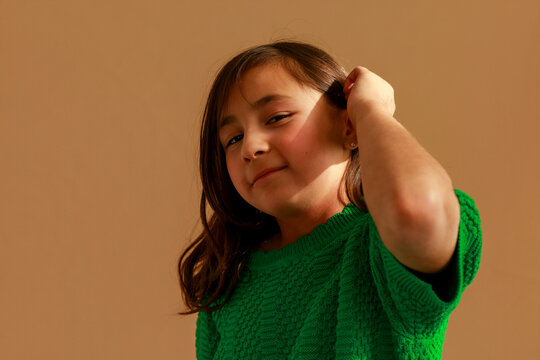Girl Poses Playfully in Green Sweater 