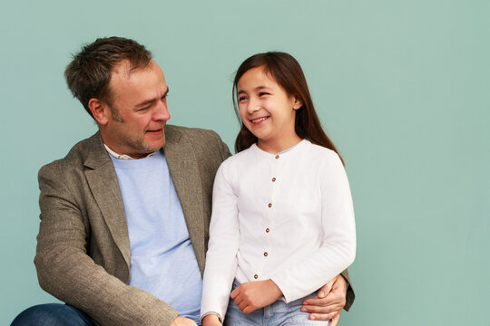Father and Daughter Share a Moment Together in a Light Setting