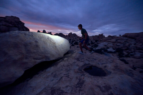 A man maintains a steady pace over the rocky ground.