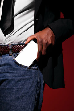Businessman Putting Smartphone in Jeans Pocket