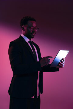 Business Professional Using Tablet in Dramatic Lighting