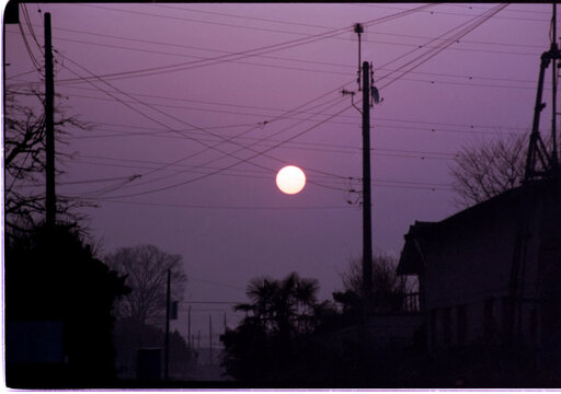 Sunset Over Utility Poles and Power Lines in Residential Japan