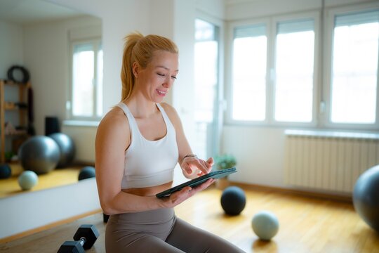 Woman using tablet during gym break
