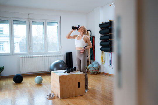 Woman hydrating after intense workout session