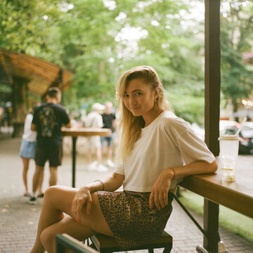 Young Woman Relaxing at Outdoor Cafe