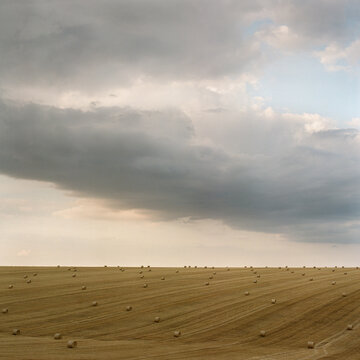 Hay Bales Across Vast Open Field