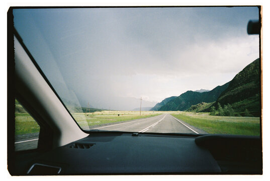 Driving on mountain road with gray sky