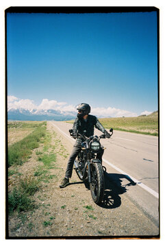 Motorcycle rider stopping on mountain road adventure