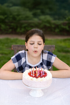 Birthday girl blowing out her birthday candles and making a wish.