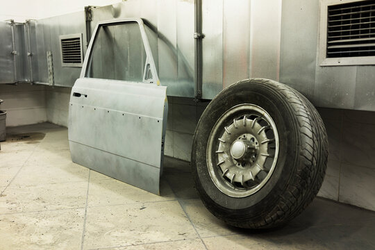 Car door and a tire in a repair shop