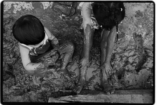 Child Playing in Muddy Ground