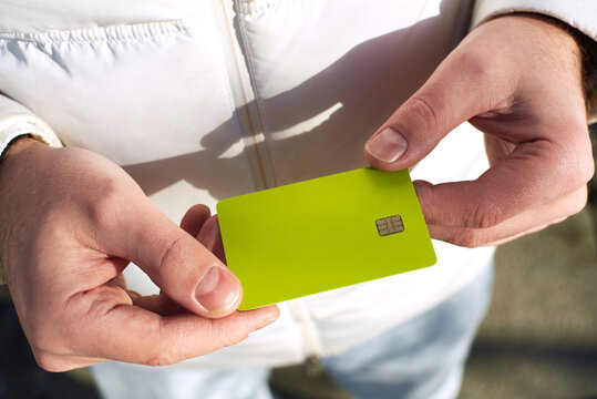 Holding a green card in hands in bright light