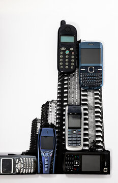 Analog collage juxtaposing mobile phones with highrise skyscrapers