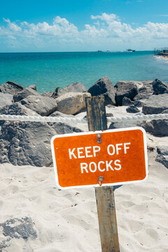 Caution sign at tropical beach