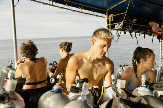 Divers Packing Scuba Gear on Boat After Dive Koh Tao, Thailand