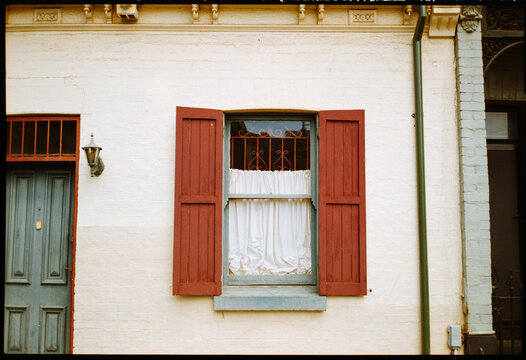 Red Shutters and Window With White Curtain on Fitzroy house