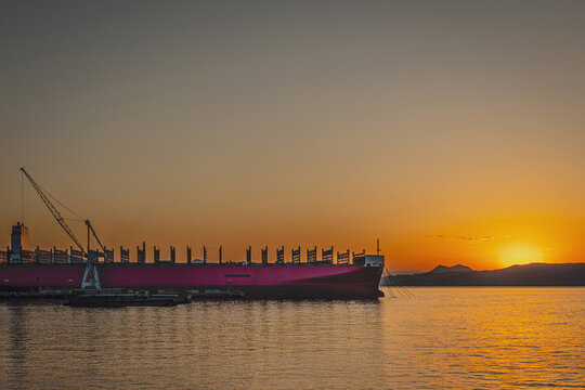 Industrial Vessel Silhouetted Against Vibrant Orange Sunset in Kure Hiroshima