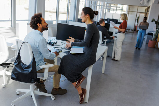 Colleagues collaborating on project in modern office