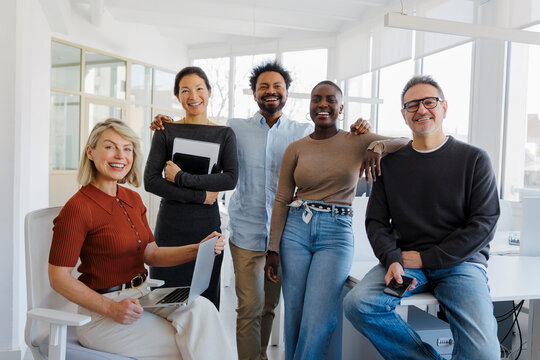 Startup team standing together in modern office setting