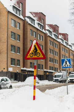 Urban Winter Street with Bicycle Warning Traffic Sign