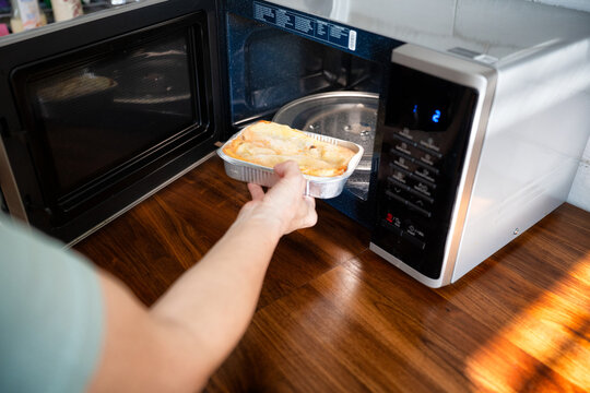 Preparing frozen ready meal lasagna in a microwave