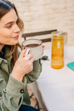 Person enjoying coffee during a relaxed social gathering