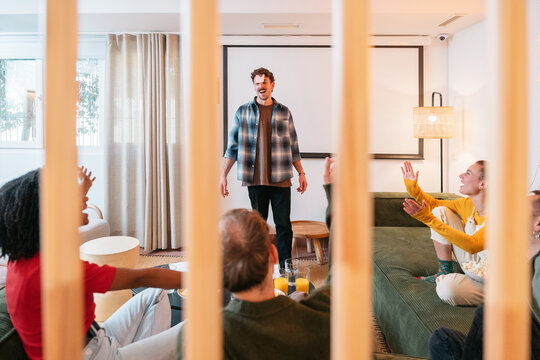 Friends playing charades game at home party