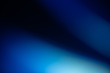 Obraz premium Abstract blurred gradient background with deep blue and bright light streaks moving across