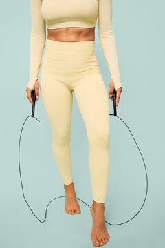 Young woman practicing fitness holding a jump rope