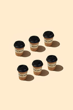 takeaway coffee cups arranged in two rows