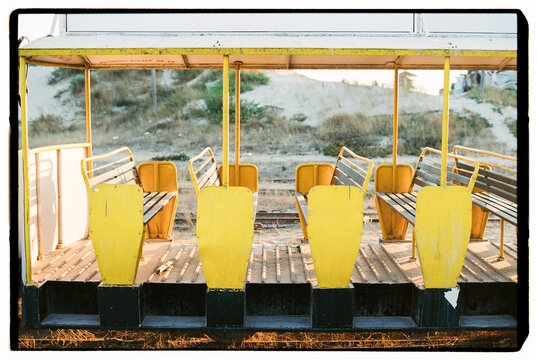 Empty yellow seats inside vintage beach train
