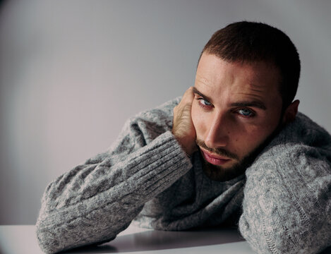 Man With Beard Resting His Head on His Hand in a Studio