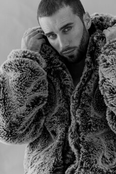 Model Poses in Fur Coat for Fashion Shoot in a Studio Setting