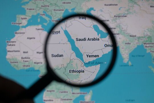 Magnifying glass over Saudi Arabia and Yemen map highlighting red sea tensions, Houthi activity, Iran influence and Strait of Hormuz trade routes shaping global security and energy supply risks.