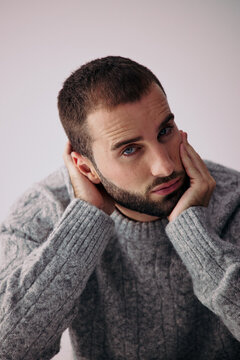 Man With Beard and Short Hair Touching His Face at Home