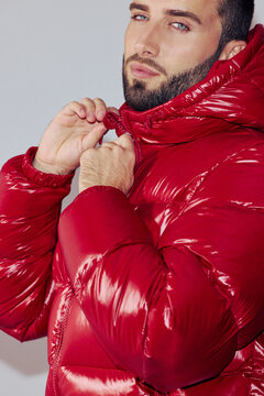 Man Zips Jacket in Indoor Setting During Winter Fashion Shoot