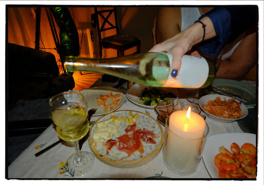 Intimate home dinner celebration with wine and candlelight