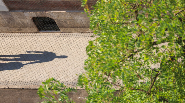 Long Shadow of a Person on City Sidewalk