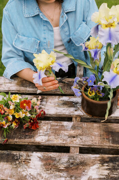 florist outdoors on farm making spring season bouquet 