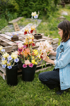 florist outdoors on farm making spring season bouquet 