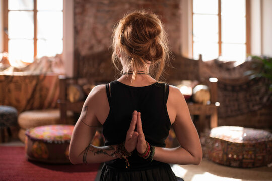 Woman meditating with hands behind back