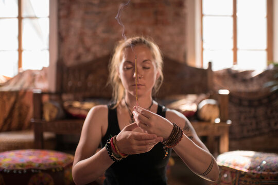 Woman burning incense during meditation