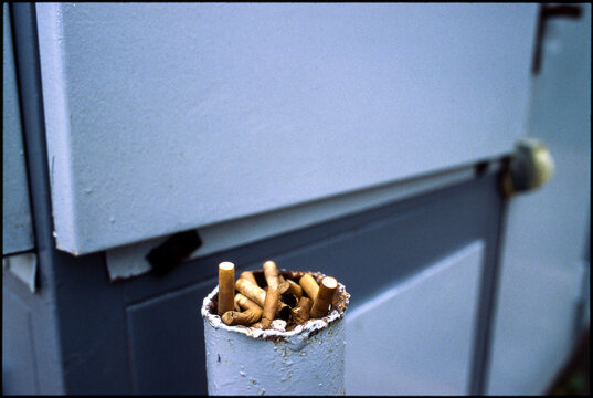Old cigarette butts in an iron stake