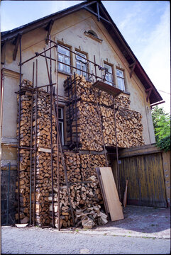 Stacked firewood against a house wall