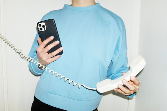 Person answering speaking to landline wire phone in work office 